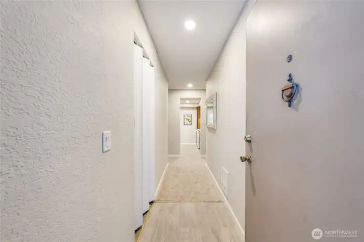 Entry features new door hardware, freshly painted walls, replaced vinyl closet doors, new carpet, & added recessed entry lights.