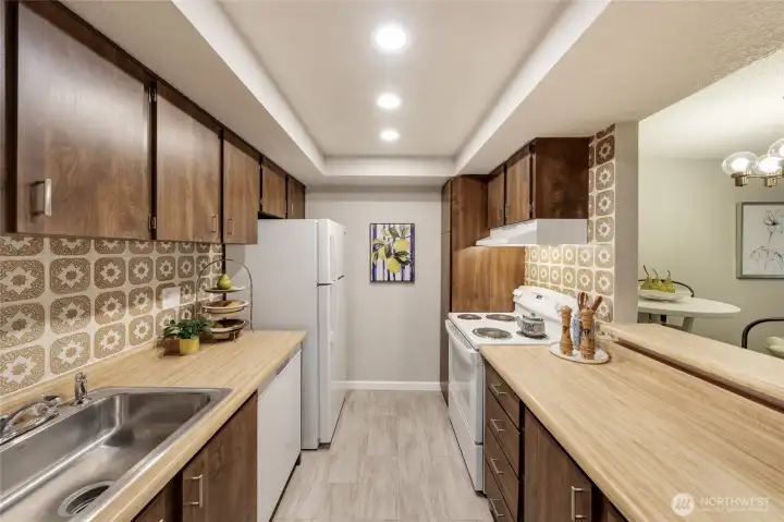 Kitchen is refreshed but retains original charm and features. Consider customizing over time while enjoying brand new appliances, range vent, updated sink, new cabinet hardware, and improved lighting.