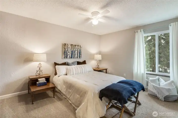 Primary bedroom window hardware conveys (not curtains). New ceiling fan elevates this room's form & function.