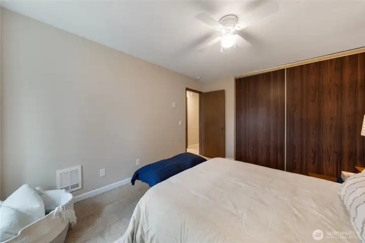 New wall heater and baseboard trim. Large sliding closet doors open to fresh storage space including new closet shelving & rod.