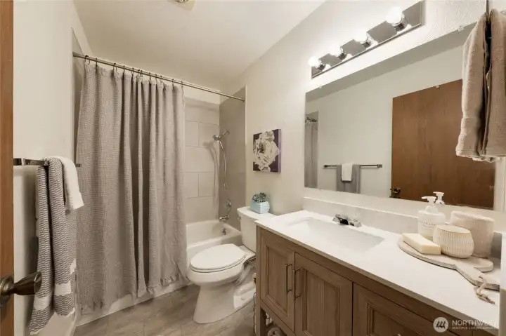 Sink vanity is a wonderful size with extra long quartz countertop and space below for organizers or towels.