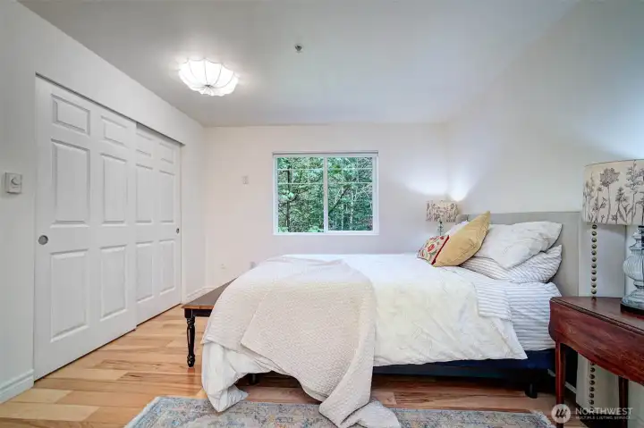 Spacious primary bedroom with an updated lighting fixture.
