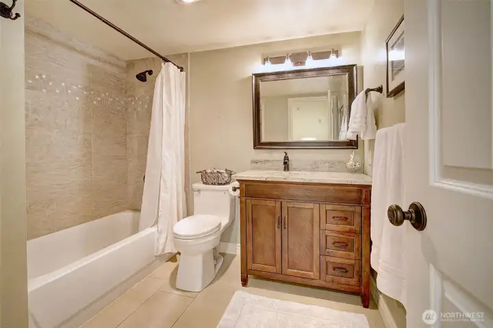 Updated full bathroom off the hall, featuring a lovely vanity & ceramic tile accents.