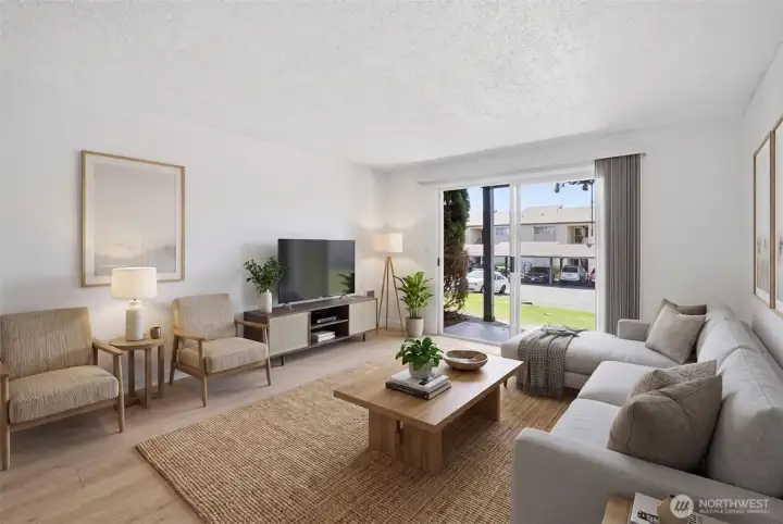 Bright and open dining and living space with access to outdoor patio.  Virtually staged.
