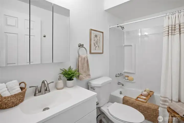 Upgraded bathroom with full tub and shower, and new vanity and sink. Virtually staged.