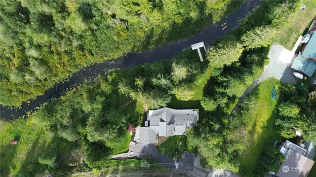 Aerial view of the home and outlet creek.