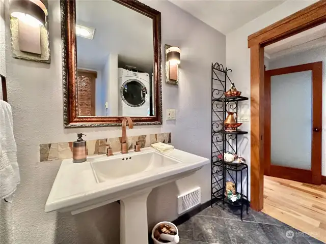 Powder room is complete with washer/dryer.