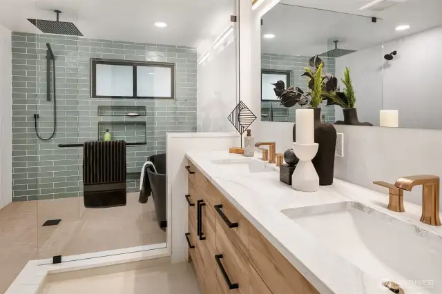 Primary en-suite bathroom fit for a spa: fully tiled wet room, soaking tub, custom lighting and cabinetry, water closet, triple shower heads, and dual vanity