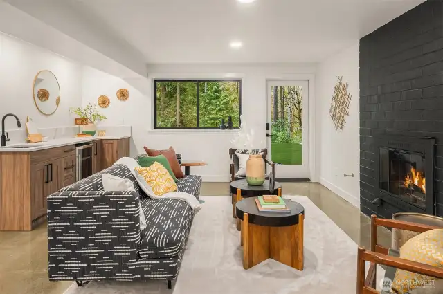 Lower level den/bonus room with polished concrete flooring, separate entrance, and custom wet bar