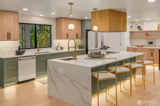 Chef's kitchen with waterfall quartz oversized island, GE Cafe appliance suite with 6-burner range, custom cabinetry and copper finishes