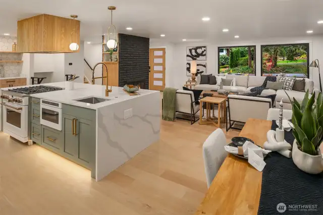 Engineered light wide plank light oak flooring throughout creates seamless flow