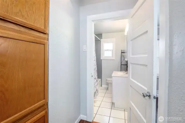 Full-sized bath with floor-to-ceiling tile