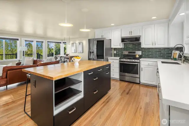 Open concept living - this kitchen has freshly painted cabinets, new quartz countertops and backsplash and newer SS appliances.