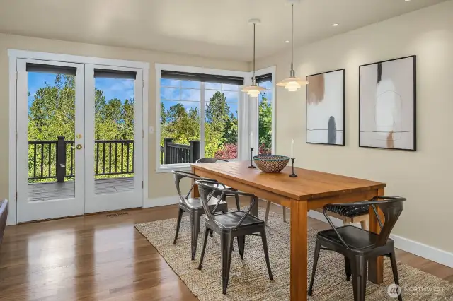 Dining area with French doors that lead to the entertainment deck and territorial views of the mountains. Notice the designer ligting with mini cams to feature art. Designer brand lights with Lutron lighting control systems.