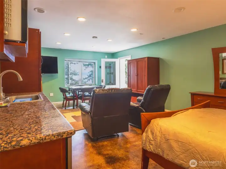 Lower level living quarters with second bedroom, full bath, living area & dining area.