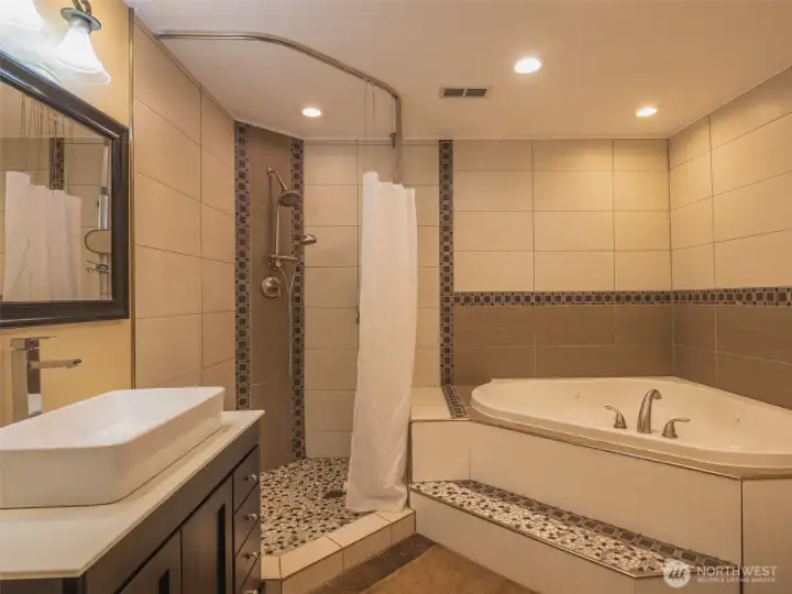 Full bath features a jetted tub shower and heated floors.