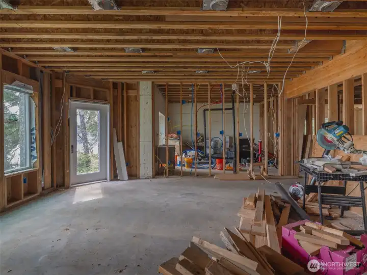 Great room looking South with 2 bedrooms. Second BR at left has slider to the outdoors. Third BR at right hidden. All the bedrooms have access to the outside of the home.
