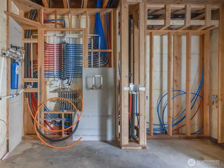 Mechanic room w/ radiant heating for basement & water purification system. To right is main washer & dryer for home & utility sink.