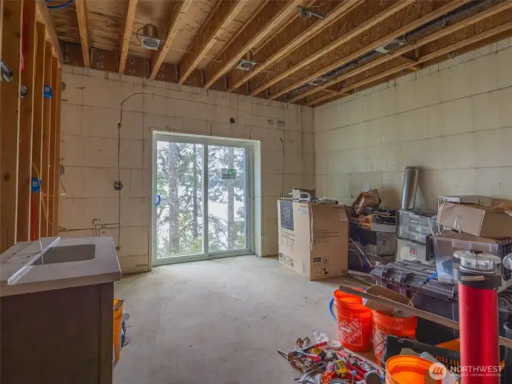 Second bedroom also featuring outdoor access on the water side of the home.  Home is built with insulated concrete form construction for added energy effiiciency and sound proofing.