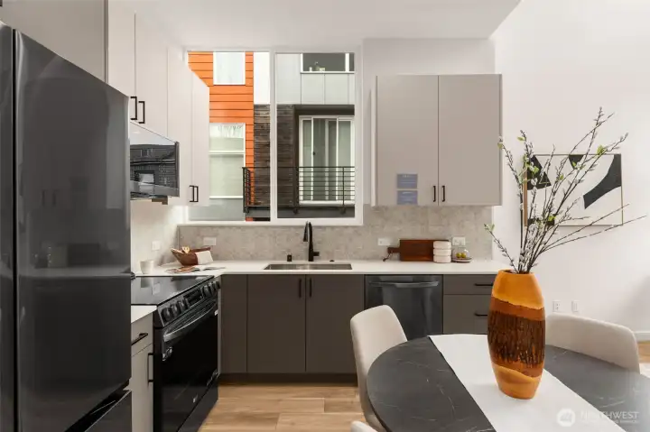 Your daily dose of natural light starts right here. This sleek kitchen is framed by oversized windows and flat-panel cabinets that scream style.