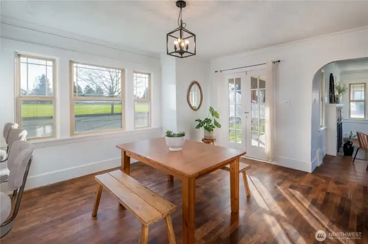 Large dining space, original French doors lead out to the oversized wrap-around porch.