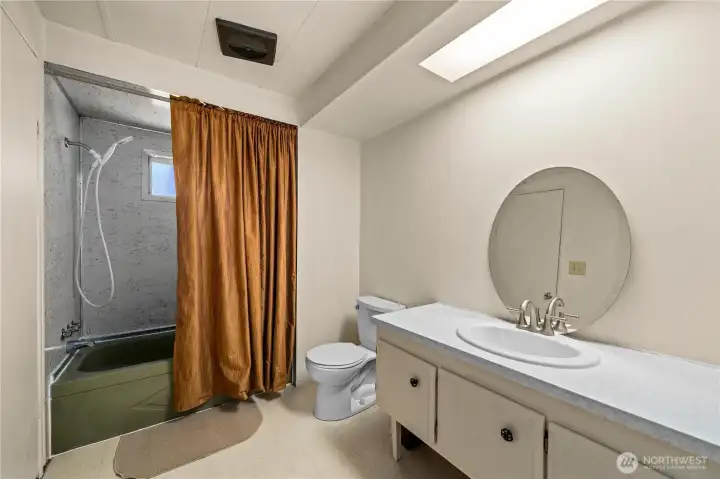 Full guest bath with shower-tub combo and spacious vanity, ideal for visitors or everyday use.