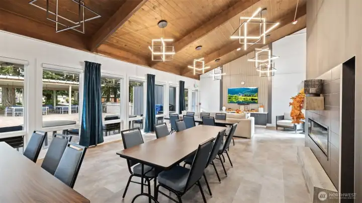 Spacious clubhouse gathering room with fireplace and dining space—ideal for community events and social gatherings.