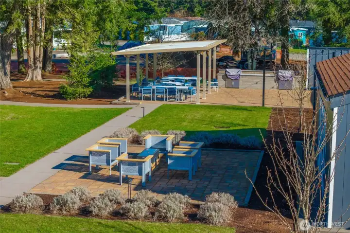 Beautiful shared outdoor space with seating, BBQ area, propane fireplace, and room to relax with neighbors and friends.