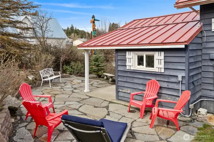 You can see the detail in the flag stone patio. It is wired and ready for a hot tub. Great place to spend time around a fire or have a BBQ. See totem pole in the view. The totem pole does not convey.
