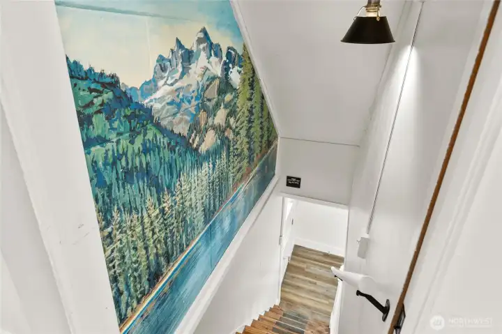 On main floor hallway is your stairs that take you to 2 more bedrooms and a bath on the lower floor. This beautiful custom painting brings the beauty of the outdoors inside.