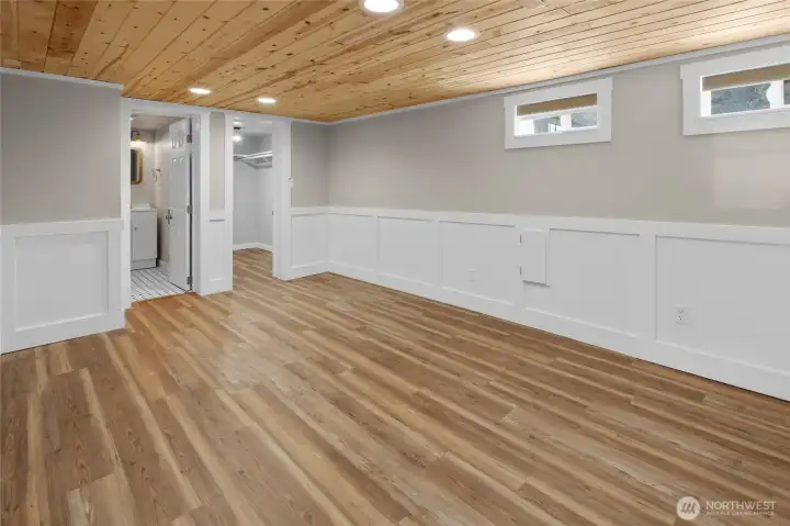 View of 2nd primary bedroom this one is located on the lower floor. The charming wainscot and wood floors make this room appealing and attractive.
