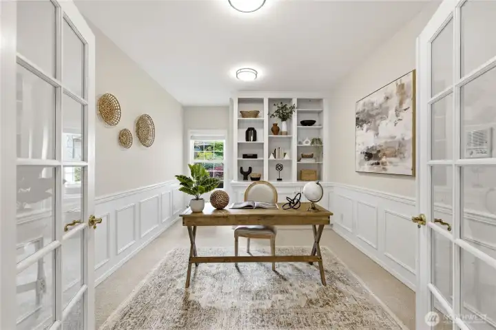 French doors invite you into the main floor office with stylish built-ins and cabinets below