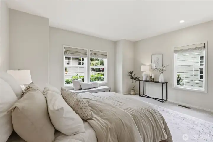 Primary bedroom features roman shades