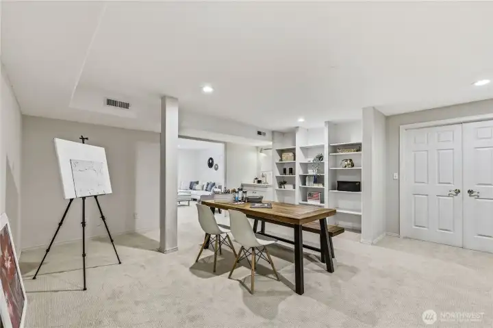 Heading downstairs to one of the two bonus rooms. This one is a perfect arts and crafts room! Note built-in shelving. Double doors lead to utility room housing furnace and water heater