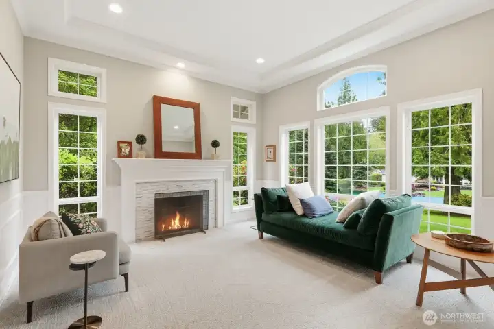 Formal living room with fireplace, wainscoting and double crown molding.