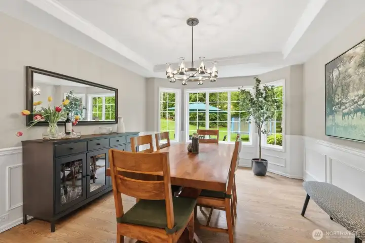 Formal dining room with wainscoting, crown molding and new chandelier.