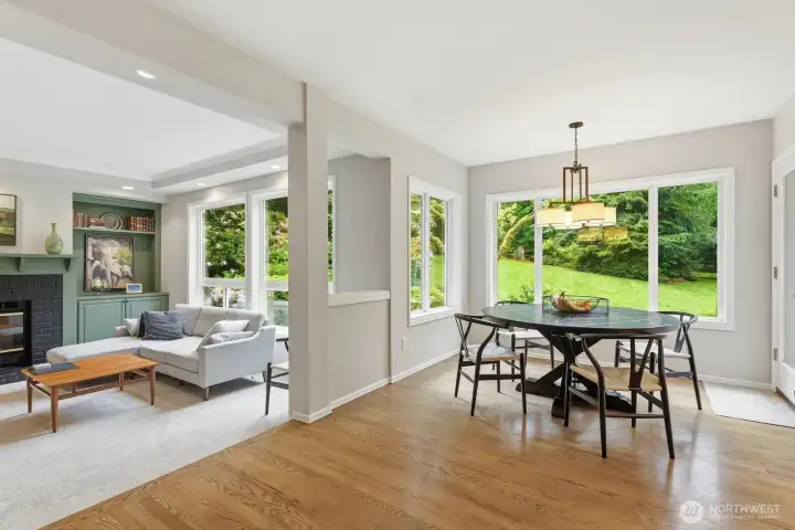 Adjacent informal dining overlooks the lush backyard and opens directly to an expansive patio designed for effortless indoor-outdoor living.