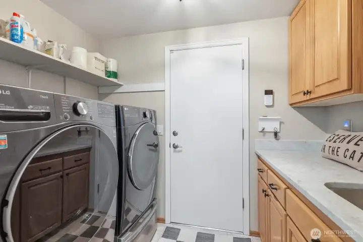 Laundry room with a valet/mini washer under the washing machine.