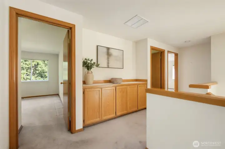 Upstairs built-ins in the hallway with the guest beds and bath on both sides