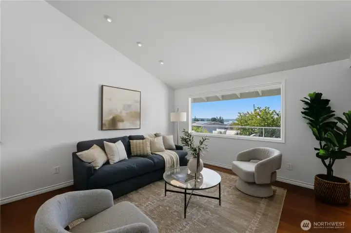 The living room features a large picture window showcasing beautiful sky, mountain, and Puget Sound views. The living room features a large picture window showcasing beautiful sky, mountain, and Puget Sound views.