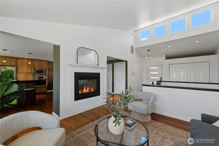 The living room also features a cozy two-sided gas fireplace and opens seamlessly to the expansive remodeled kitchen. The living room also features a cozy two-sided gas fireplace and opens seamlessly to the expansive remodeled kitchen.