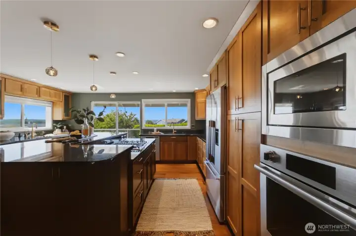 From here, you can appreciate just how expansive this kitchen is. Premium appliances include a Wolf range and Fisher & Paykel refrigerator. From here, you can appreciate just how expansive this kitchen is. Premium appliances include a Wolf range and Fisher & Paykel refrigerator.
