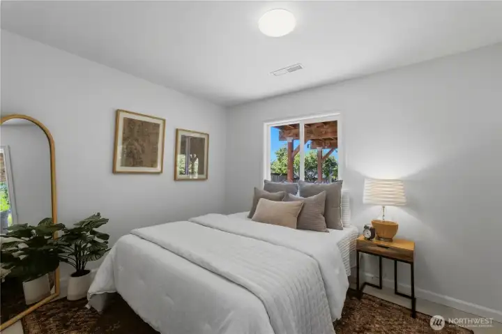 This is one of two spacious lower-level bedrooms, each featuring large windows, modular closet systems, cedar-lined closets, and tile flooring. This is one of two spacious lower-level bedrooms, each featuring large windows, modular closet systems, cedar-lined closets, and tile flooring.