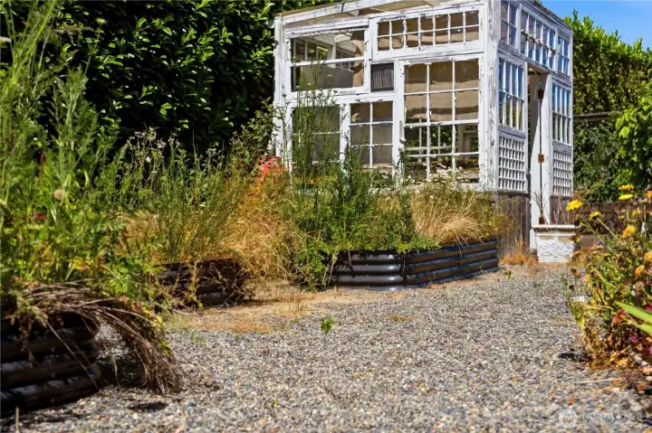 You'll also find a charming rustic greenhouse, perfect for gardening tools, potting projects, and seasonal planting. You'll also find a charming rustic greenhouse, perfect for gardening tools, potting projects, and seasonal planting.