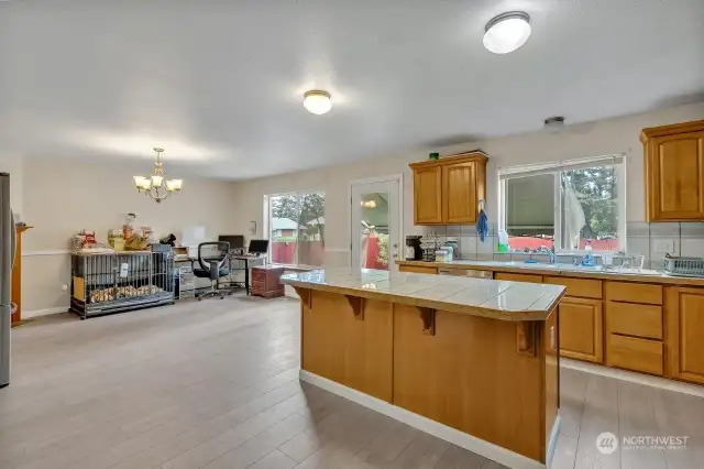 Gatherings are easy with the kitchen open to the family room; currently being used as a dining area.