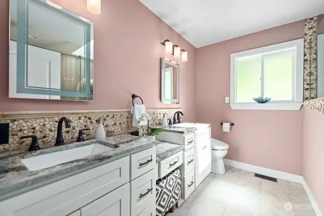 Luxurious primary bath with 2 sinks, prep area and skylights!