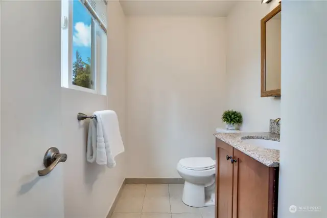 An ensuite off the primary bedroom offers tile floors, a sunny window, updated fixtures and newer paint.