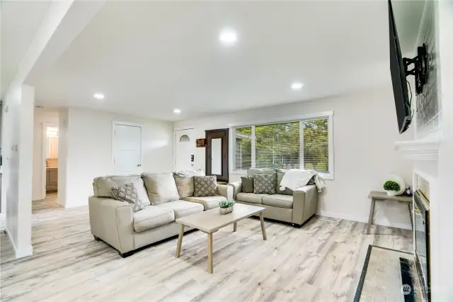 The living room flows seamlessly to each side of the home. Bedrooms and updated baths on one side, utility/mud room & flex space on the other. The luxury plank flooring and recessed lighting tie in each room and guide you through this multi-functional floorplan.