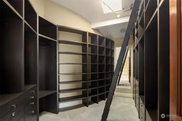 Step into luxury with this spacious walk-in closet, meticulously designed to accommodate your wardrobe with ample room for organization.