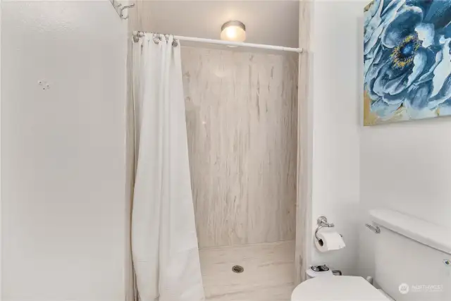 Gorgeous updated primary bath with a large walk-in shower.